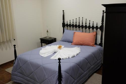 a bedroom with a bed with a blue comforter at Casa Lagar in Vale de Cambra