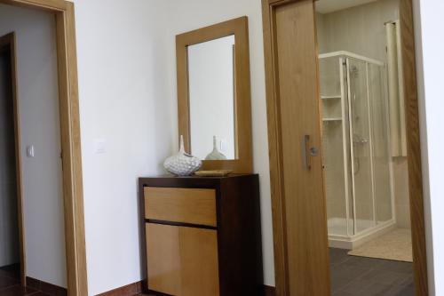 a mirror on top of a dresser in a room at Casa Lagar in Vale de Cambra