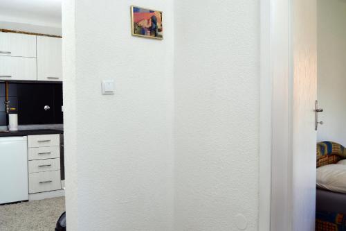 a door to a kitchen with a picture on the wall at Apartmani Balibeg in Sarajevo