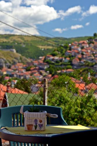 a table with a cup sitting on top of a balcony at Apartmani Balibeg in Sarajevo