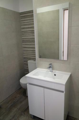 a bathroom with a white sink and a toilet at Lisbon Beach Apartments 8 in Costa da Caparica