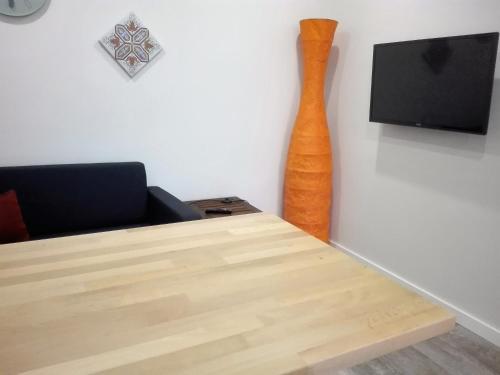 a room with a table and a vase on the wall at Lisbon Beach Apartments 8 in Costa da Caparica