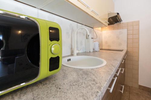 a bathroom with a white sink on a counter at Apartments & Rooms Laganini in Zaton