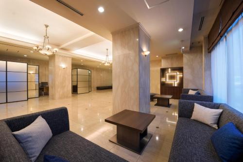 a lobby with couches and a table in a building at Hotel JAL City Sendai in Sendai