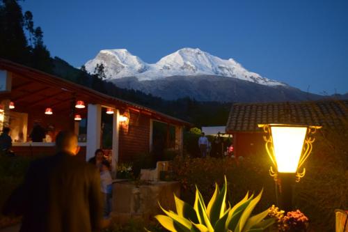 a man standing in front of a house with a mountain at La Casita de mi Abuela in Mancos