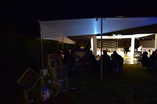 a group of people sitting under a tent at night at La Casita de mi Abuela in Mancos