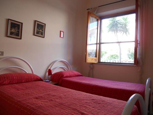 A bed or beds in a room at Villa Magnolia Appartamenti