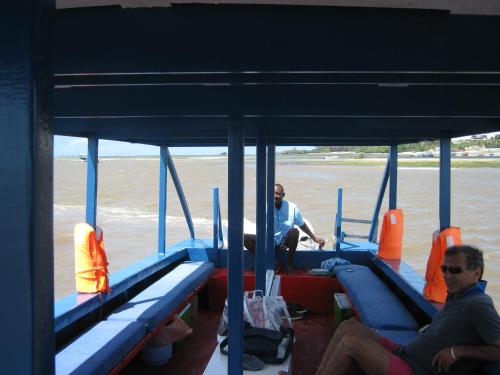two men sitting on a boat in the water at Scorpio Villas Resort in Malindi