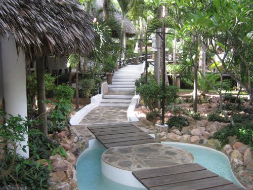 a walkway leading to a pool in a resort at Scorpio Villas Resort in Malindi