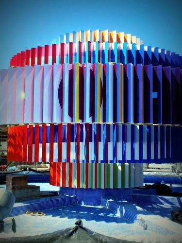 a building with a colorful facade in the snow at Cinema Hotel - an Atlas Boutique Hotel in Tel Aviv