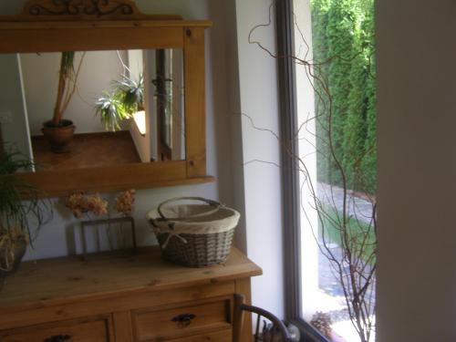 a mirror on top of a dresser in a room at Pod lasem in Charzykowy