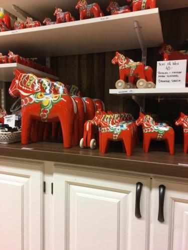 a shelf with a group of red elephants on it at Stallet - Hemma hos Mait in Mora