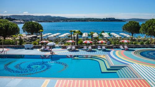 a hotel swimming pool with a view of the water at Pension Silvia in Portorož
