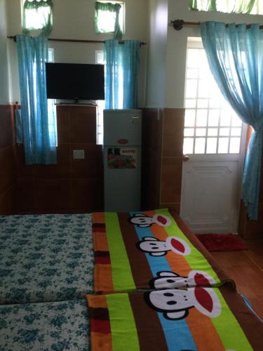 a bedroom with a hello kitty blanket on a bed at Nhu Y Guesthouse in Phan Rang–Tháp Chàm