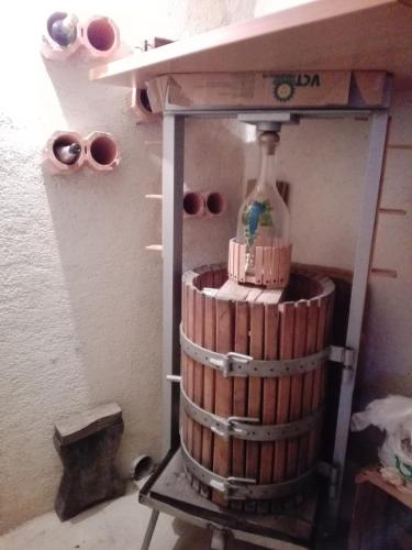 a bottle of wine in a barrel in a room at Getaway "At the three lights" in Sevnica