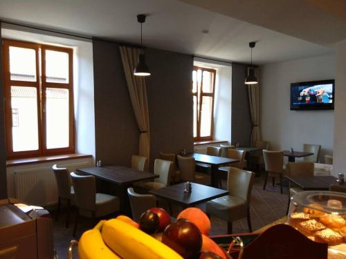 a restaurant with tables and chairs and fruit on a table at Pension Viktorin in Poděbrady
