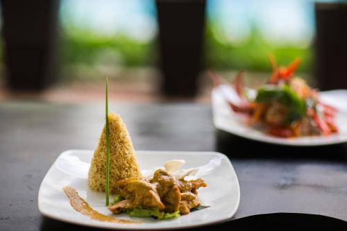 a white plate with a sandwich on a table at Le Chanthou Boutique in Siem Reap