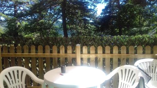 a table and chairs in front of a fence at Loft Les Tourelles in Andon