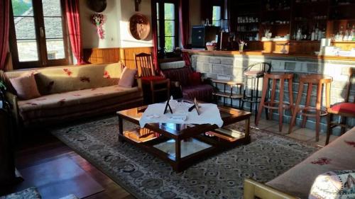 a living room with a couch and a table at Hotel Papigo in Papigko