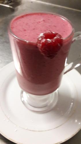 a red drink in a glass on a plate at The Old Bank Bruff Family Town House in Bruff
