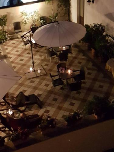 an overhead view of a patio with an umbrella and chairs at Palazzo Volta Boutique Luxury B&B in Nardò