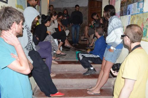 a group of people sitting on steps in a room at Alojamiento El Cardon Tilcara in Tilcara