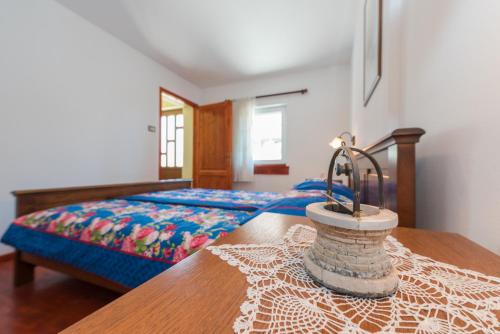 a bedroom with a bed and a wooden table at Kuća za odmor Pavincica in Labin