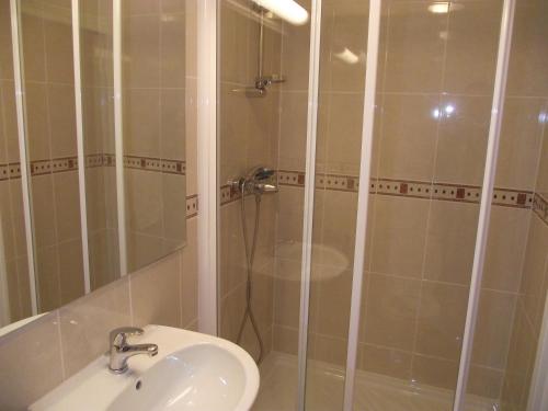 a bathroom with a shower and a sink at Le Nouvel Hôtel du Théâtre in Paris