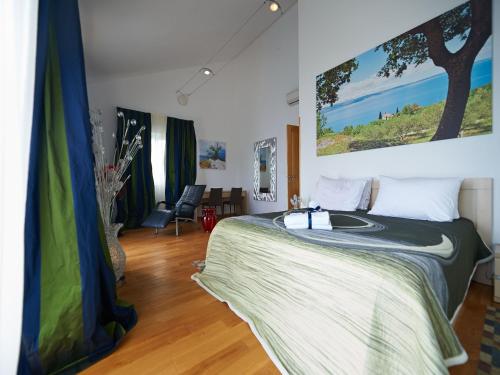 a bedroom with a bed with a large painting on the wall at Villa Maranata-5 stars-pool-spa-gym-free parking-privacy in Jesenice