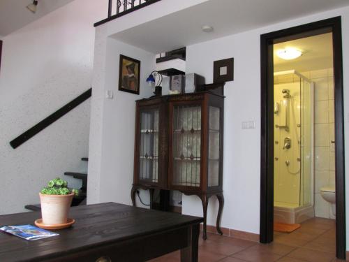 a living room with a wooden cabinet and a table at Črni Baron Pension Black Baron in Maribor