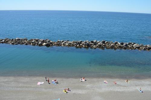 a group of people on a beach near the water at Hotel San Pietro Chiavari in Chiavari