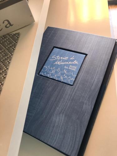 a book with a blue card on a table at Le Storie di Manarola in Manarola