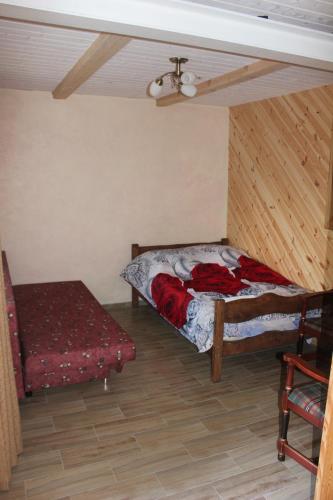 a small room with a bed and a table at Vilkdvaris in Plungė