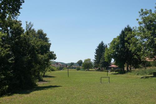 a grassy field with a basket in the middle at Apartments Korana, BelajskePoljice in Duga Resa