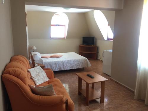 uma sala de estar com um sofá e uma cama em Family Hotel Selena em Nessebar