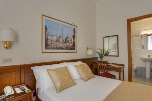 um quarto com uma cama branca e um telefone em Hotel Silla em Roma