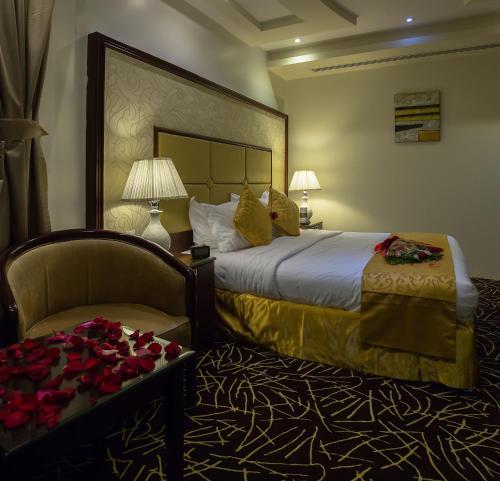 a hotel room with a bed and a chair at Rest Night Serviced Apartments- AlHamra in Riyadh