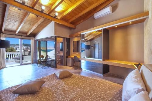 a bedroom with a large bed and a living room at Minoos Hotel in Chania Town