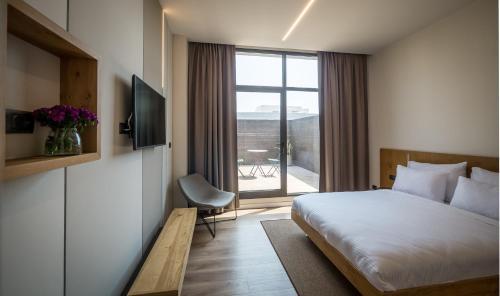 Postel nebo postele na pokoji v ubytování La Cappella Business Boutique Hotel