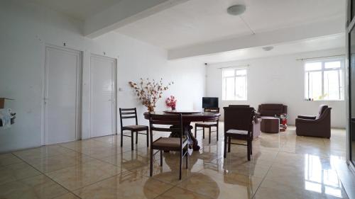 a dining room with a table and chairs at La Dorade in Trou aux Biches