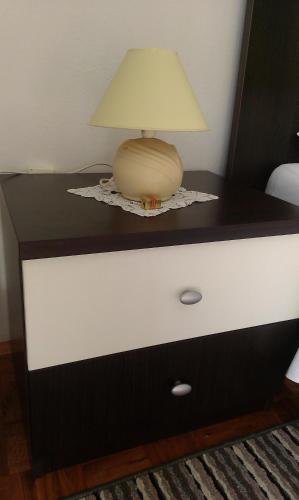 a lamp sitting on top of a dresser at Apartman Tribunj in Tribunj