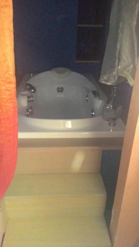 a white bath tub sitting on top of a sink at Sky Wellness Apartment in Porto SantʼElpidio