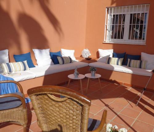 a living room with a couch with pillows on it at Manilva Beach 140 in Manilva