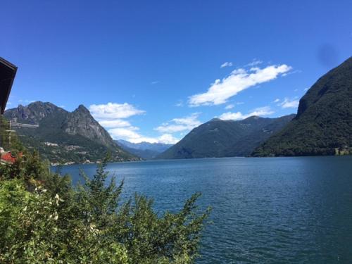 a view of a lake with mountains in the background at Hotel Concordia in Porlezza