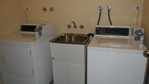 a small kitchen with a sink and a microwave at Sheffield Motor Inn in Sheffield