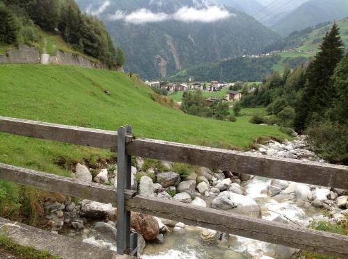 a fence next to a river in a valley at Disentis in Disentis