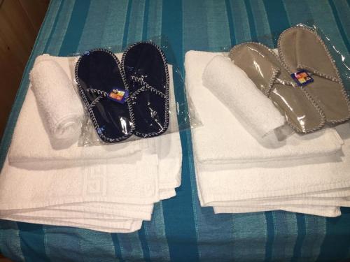 two towels and sandals sitting on top of a table at B&B Le Stagioni in Castel del Monte
