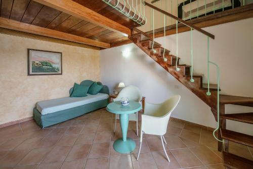 a living room with a bed and a staircase at Hotel La Corricella in Procida