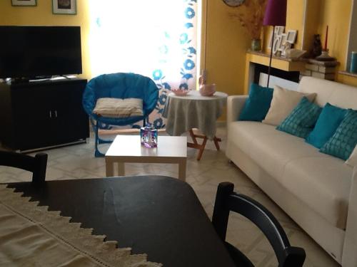 a living room with a couch and a table at Stella Del Sud in Cuglieri