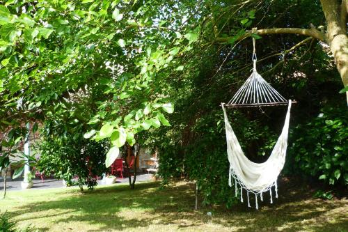 a hammock hanging from a tree in a park at Las Casonas de Avellaneda in Navia